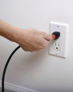 three electricians inspecting a home's generator