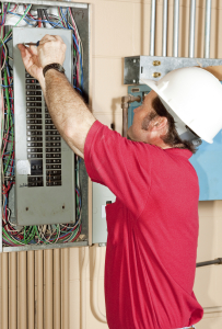 electrician inspecting an electrical panel