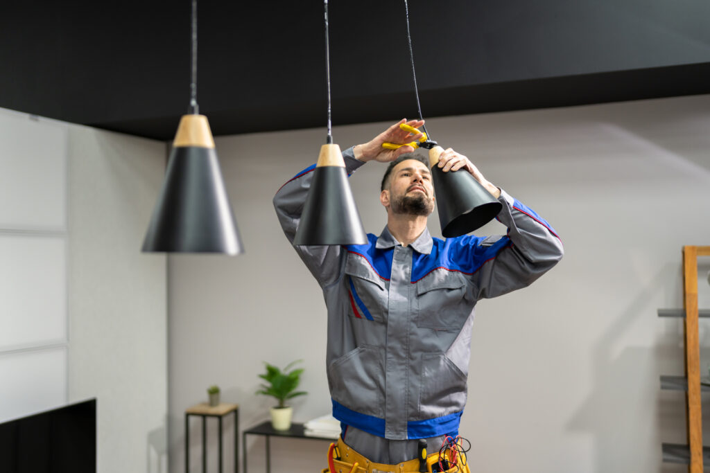 electrician installing pendant lights